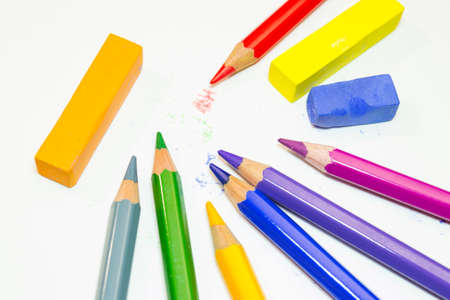 Colored pencils and crayons on a white background. Materials for artists.