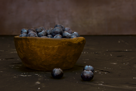 blueberry in a ceramic bowl of clay on a vintage backgroundの写真素材