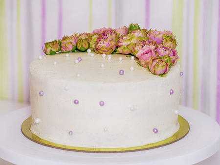 low-calorie handmade cake, decorated with fresh roses and decor