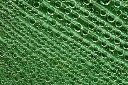 Abstract background of green bubbles of different sizes. macro