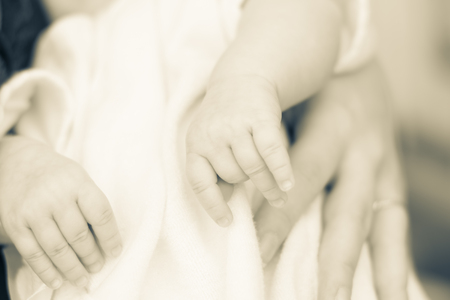 gentle touch of the hands of mothers and pens of a newborn baby. close-up. Blur.の写真素材