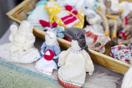 national dolls in beautiful dresses and handmade hats at the exhibition on the streetの写真素材
