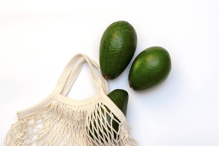 Avocado in a string bag on a white background.zero wasteの写真素材