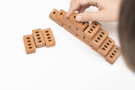 Construction of small brick blocks, toy for child development on white background