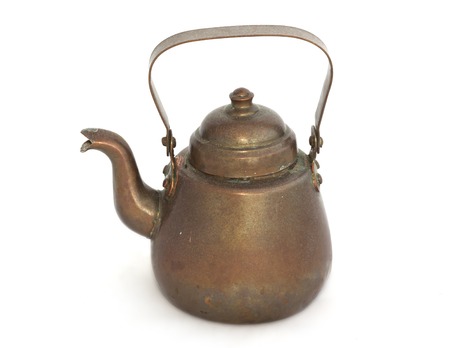 Old copper kettle on a white background