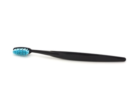 Black toothbrush on a white background, isolatedの写真素材