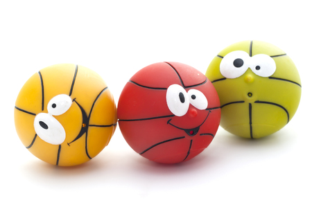 Three colorful toy basketball with faces isolated on a white backgroundの写真素材