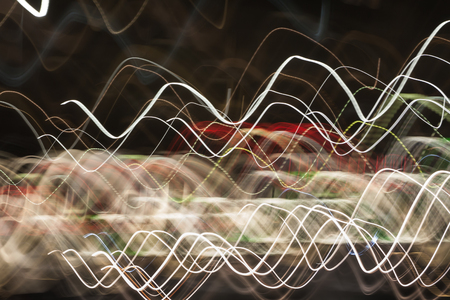 Abstract blurred colorful light effect on a black background. Long exposure photo of moving camera.の写真素材