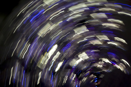 Abstract blurred light effect on a black background. Long exposure photo of moving camera round.