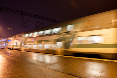 KOUVOLA, FINLAND - NOVEMBER 7, 2018: Train in motion on the station at night, long exposure photoのeditorial素材