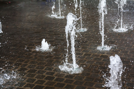 Short exposure photo of a few small fountains in Kouvola, Finland on a summer day.の写真素材