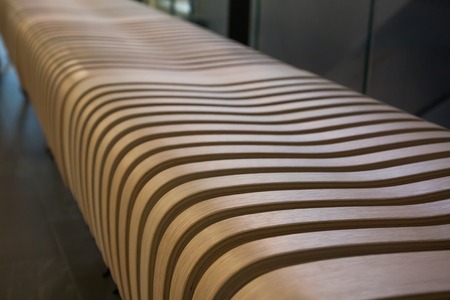 A close-up of a wooden bench in the shoppeng center.の写真素材