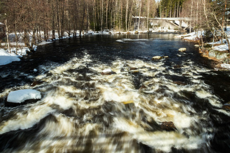 Long exposure photo. Rough river Jokelanjoki and stones in water, Kouvola, Finland.の写真素材