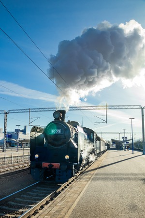 Kouvola, Finland - April 18, 2019: Old steam train Ukko-Pekka is leaving the station at morning.
