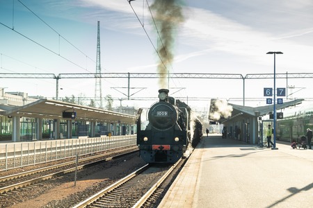 Kouvola, Finland - April 18, 2019: Old steam train Ukko-Pekka is leaving the station at morning.のeditorial素材