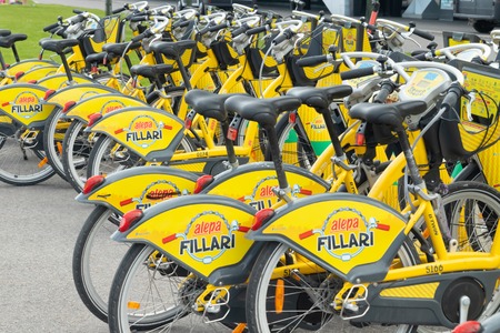 Helsinki, Finland - June 12, 2019: Yellow city bicycles for rent stand in a row in central part of...
