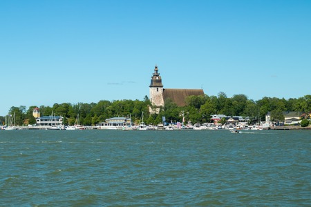 Naantali, Finland - 28 June, 2019: View from the sea of Naantali harbor and medieval stone church at sunny summer day, Finlandのeditorial素材