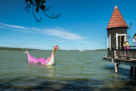 Naantali, Finland - 28 June, 2019: Bathing hut and Edvard the Booble in park Moominworld at sunny summer day.のeditorial素材