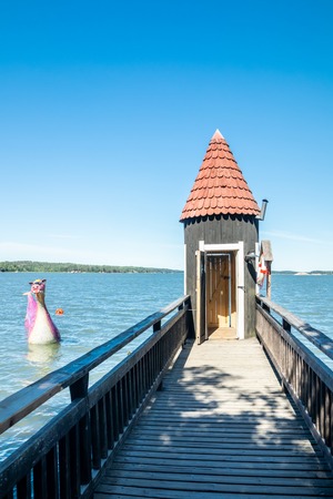 Naantali, Finland - 28 June, 2019: Bathing hut and Edvard the Booble in park Moominworld at sunny summer day.のeditorial素材