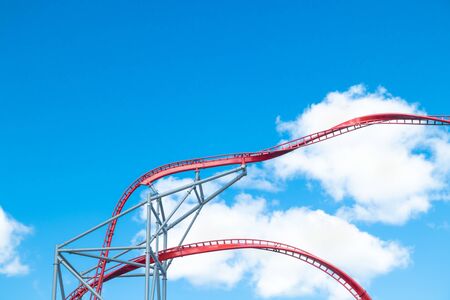 Roller Coaster in amusement park on blue sky backgroundの写真素材