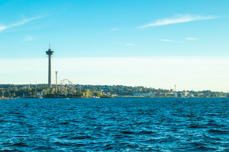 Tampere, Finland - 24 June 2019: Sarkanniemi amusement park with Nasinneula tower, view over the water at sunsetのeditorial素材
