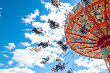 Tampere, Finland - 24 June 2019: Ride Swing Carousel in motion in amusement park Sarkanniemi on blue sky backgroundのeditorial素材