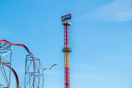 Tampere, Finland - 24 June 2019: Seagull and Rides Boom and Roller Coaster in amusement park Sarkanniemi.のeditorial素材