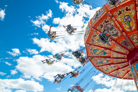 Tampere, Finland - 24 June 2019: Ride Swing Carousel in motion in amusement park Sarkanniemi on blue sky backgroundのeditorial素材