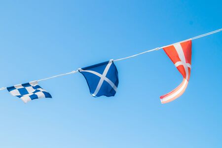 Nautical flags on the ship against blue skyの写真素材