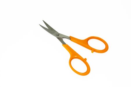 Scissors with orange handles on a white backgroundの写真素材