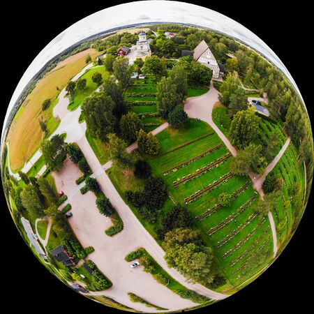 A three dimensional panoramic view of the medieval greystone Church of St. Mary in Hollola, Finland in a mini planet panorama style.の写真素材