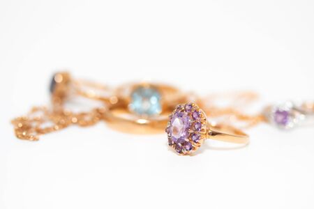 Collection of jewelry with beautiful golden ring with purple stone isolated on white background