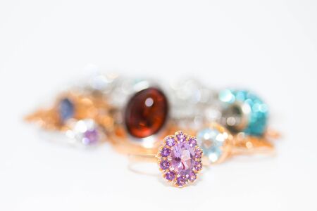 Collection of jewelry with beautiful golden ring with purple stone isolated on white backgroundの写真素材