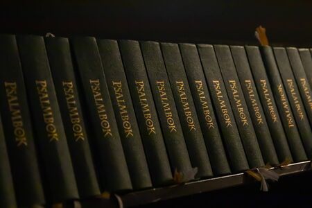 Porvoo, Finland - 2 October 2019: Closeup of a row of green hymn books on swedish language in Porvoo...