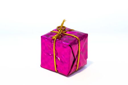 Gift box with golden ribbon isolated on whiteの写真素材