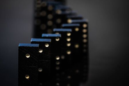 Black vintage dominoes on a black background, selective focus
