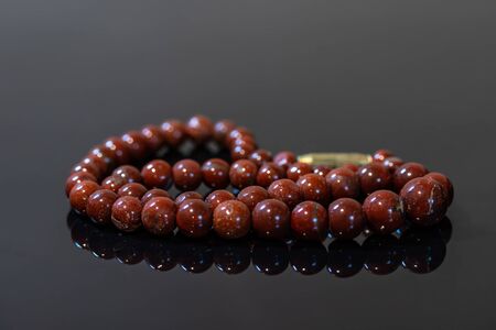 Brown jasper beads isolated on black backgroundの写真素材
