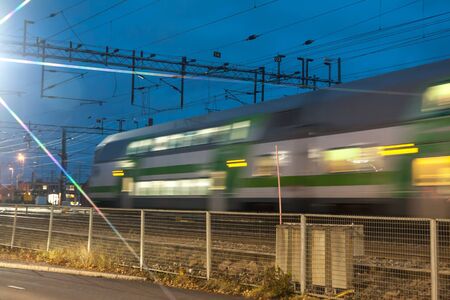 Train in motion on the station at night, long exposure photo