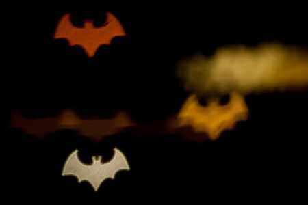Blurred photo of defocused bokeh colorful lights in the shape of bat.の写真素材