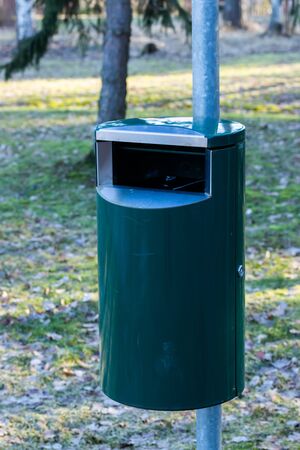 Green metal trash can in a park in Finlandの写真素材