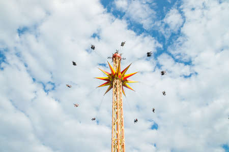 Kouvola, Finland - 10 August 2019: Ride Star Flyer in motion on cloudy sky background in amusement park Tykkimakiのeditorial素材