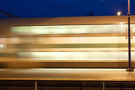 Train in motion on the station at night, long exposure photo