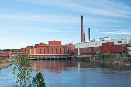 Autumn landscape of Kymijoki river waters and Myllykoski factory in Finland, Kymenlaakso, Kouvola
