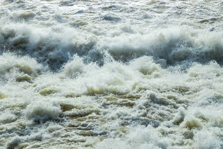 Splashing water waves on the spring fast riverの写真素材