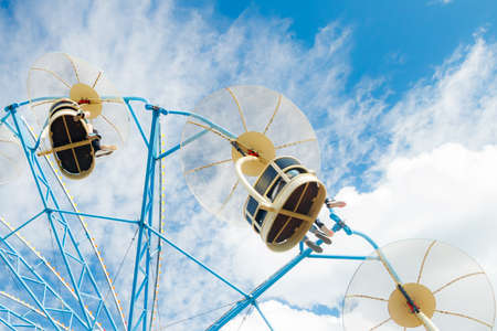 Ride carousel in motion in amusement park at sunny dayの写真素材