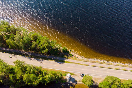 Aerial view of road on Pulkkilanharju Ridge at lake Paijanne, Paijanne National Park, Finland.