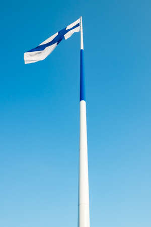The largest Finnish flag in the world and the tallest flagpole in Europe against blue sky, Hamina,...