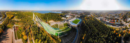 Aerial panoramic view of Lahti sports center with three ski jump towers.