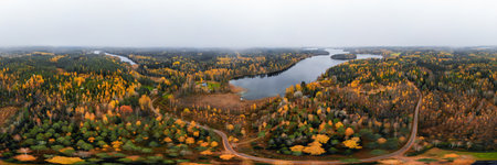Panoramic aerial view of lake and colorful forests on a autumn day in Finland. Drone photographyの写真素材