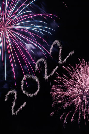 Happy New Year 2022. Sparkling burning numbers Year 2022 with firework on black background.の写真素材